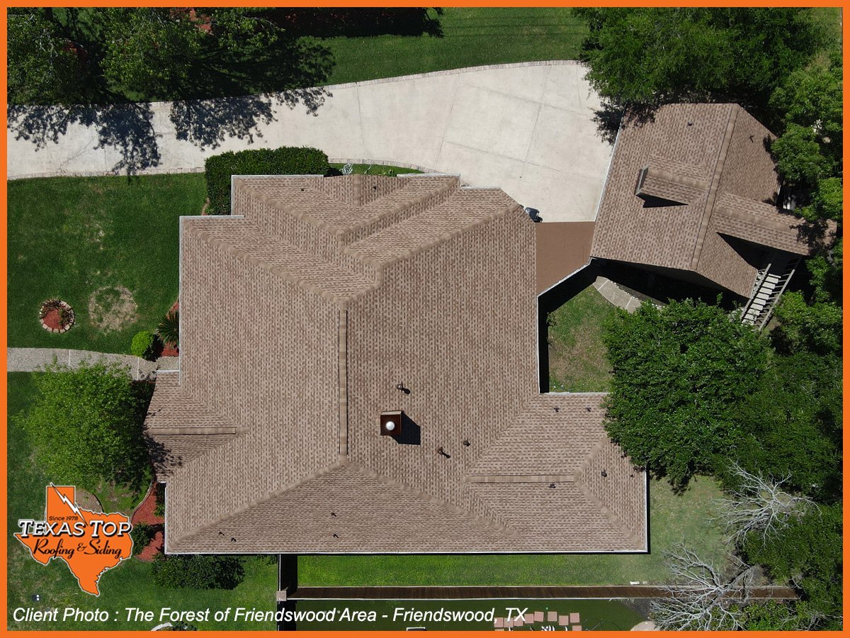 Aerial view of residential home with gray roof