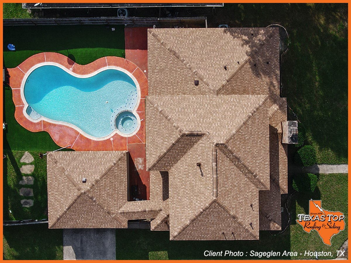 Aerial view of residential home with custom blue pool